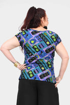 Printed teal back view crew-neck tee with colorful abstract insect-and-gear pattern