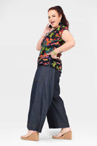 Dark blue denim wide-leg pants with patch pockets and stitched hem cuffs