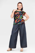 Dark blue denim long pants with relaxed wide leg, patch pockets, cuffed hems