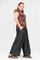 Black denim wide-leg long pants with side seam stitching and wide cuffed hem
