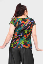Levi tee, dark with tropical leaf and bird print, back view