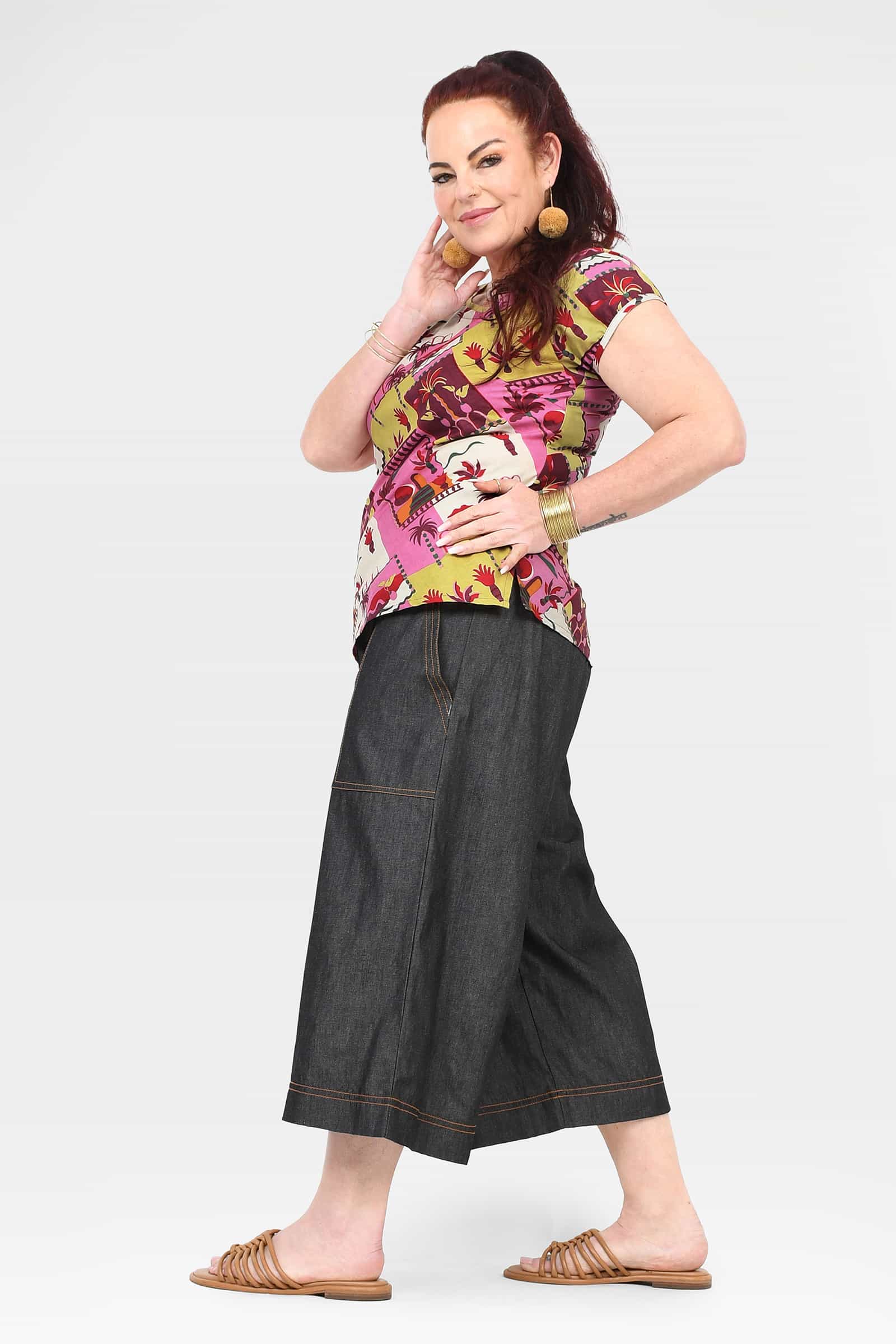 Black denim cropped 3/4 pants with wide legs and patch pockets, visible front panel