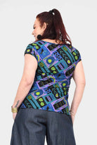 Printed teal back view crew-neck tee with colorful abstract insect-and-gear pattern