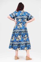 Blue midi dress with short sleeves, A-line skirt, and cityscape pattern