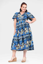 Blue midi dress with short sleeves, full skirt, and multi-scene city pattern