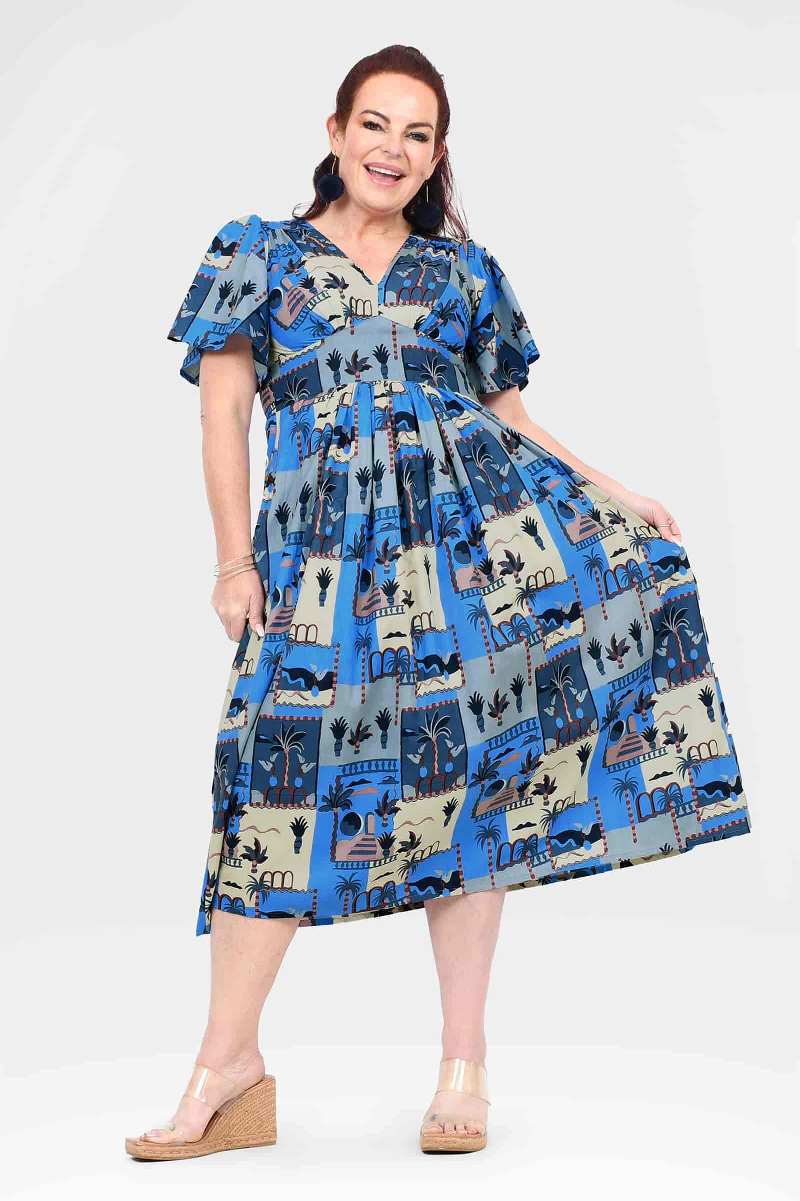 Blue midi dress with short sleeves, cinched waist, and cityscape print