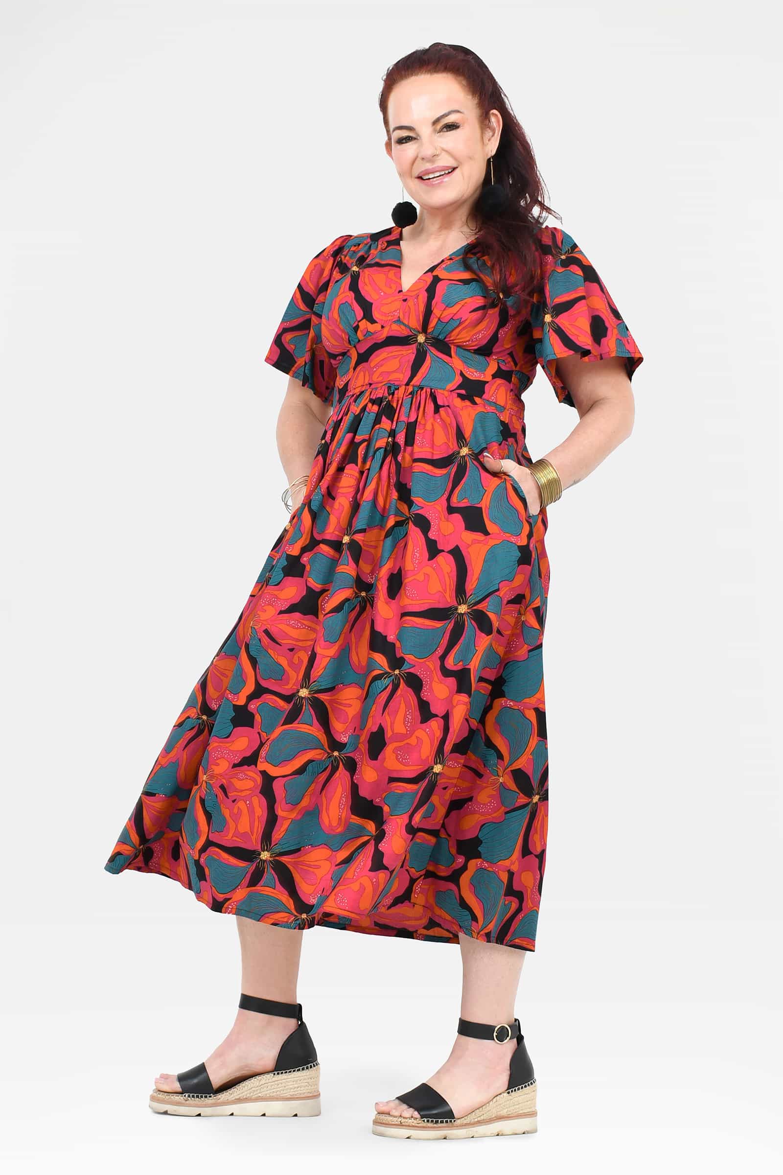 Midi dress with V-neck, short sleeves, gathered waist, and bold abstract floral print