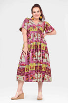 Pink midi dress with V-neck, short sleeves, and colorful patchwork print