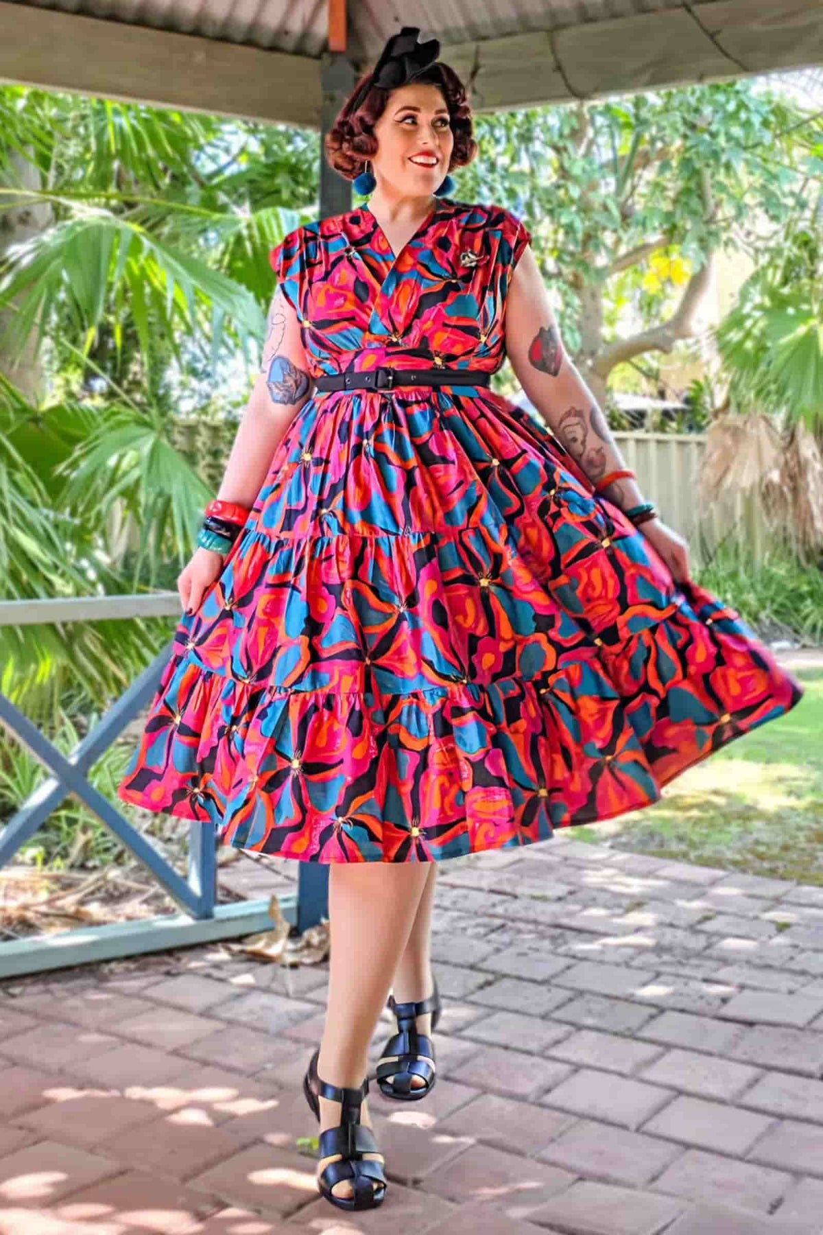 Poppy pink midi dress with colorful geometric print, collared short sleeves, tiered skirt