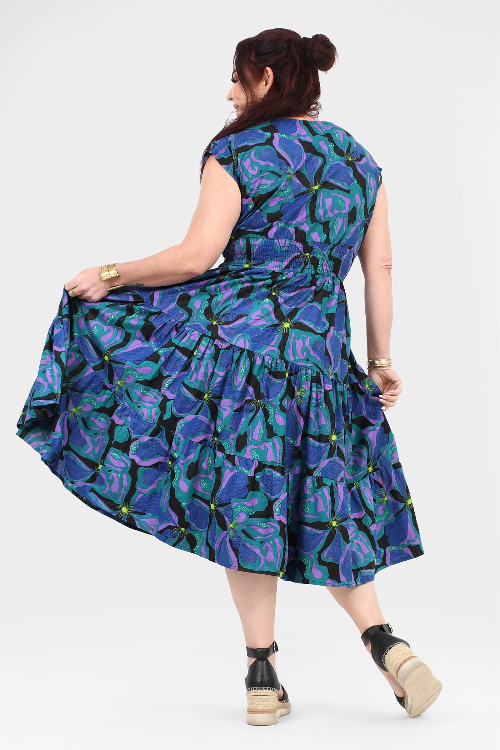 Printed teal and purple midi dress, back view, tiered skirt and cap sleeves