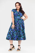 Printed teal and purple midi dress with V-neckline and gathered tiered skirt