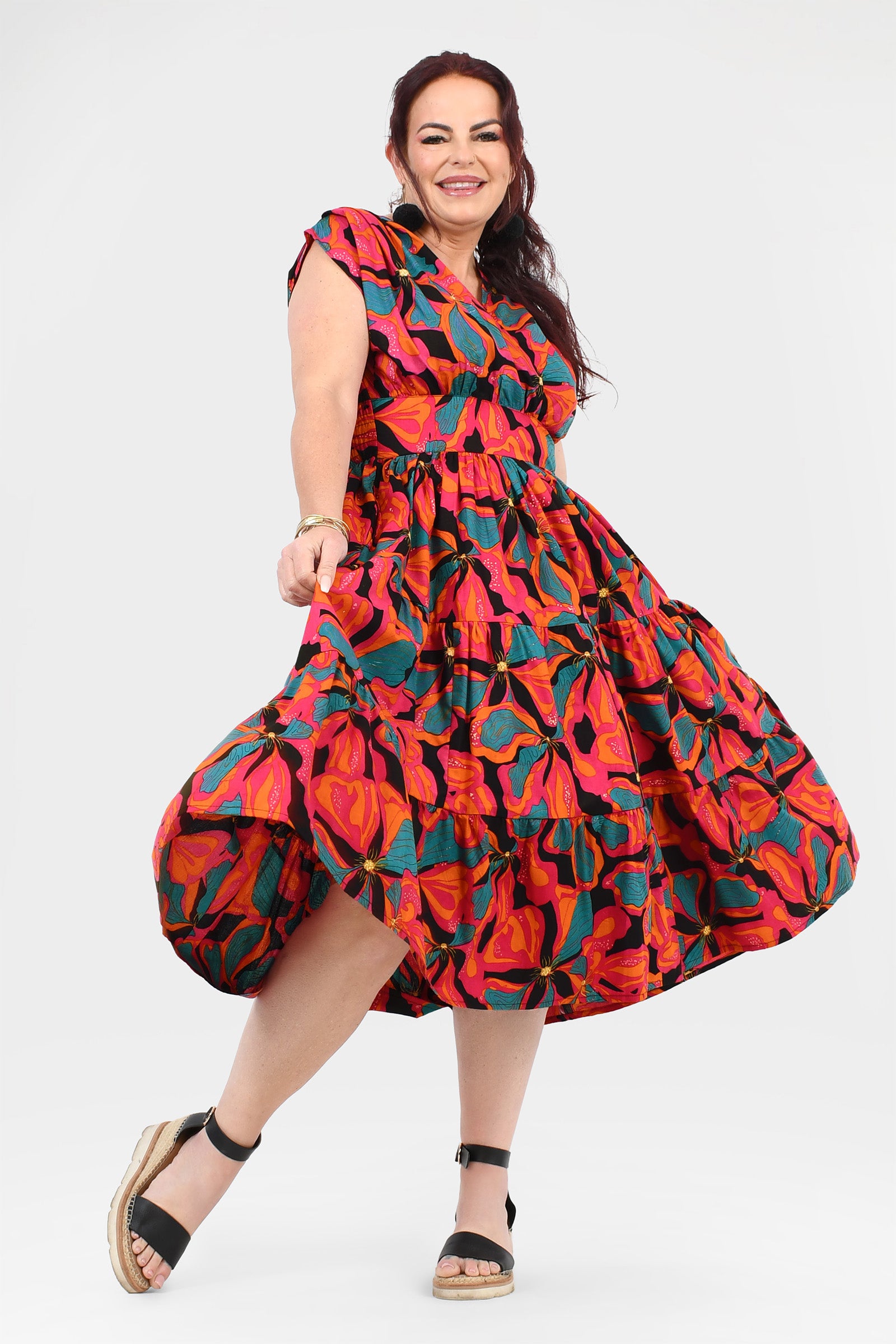 Multicolor floral midi dress with ruffled tiered skirt, short sleeves, and tied waist