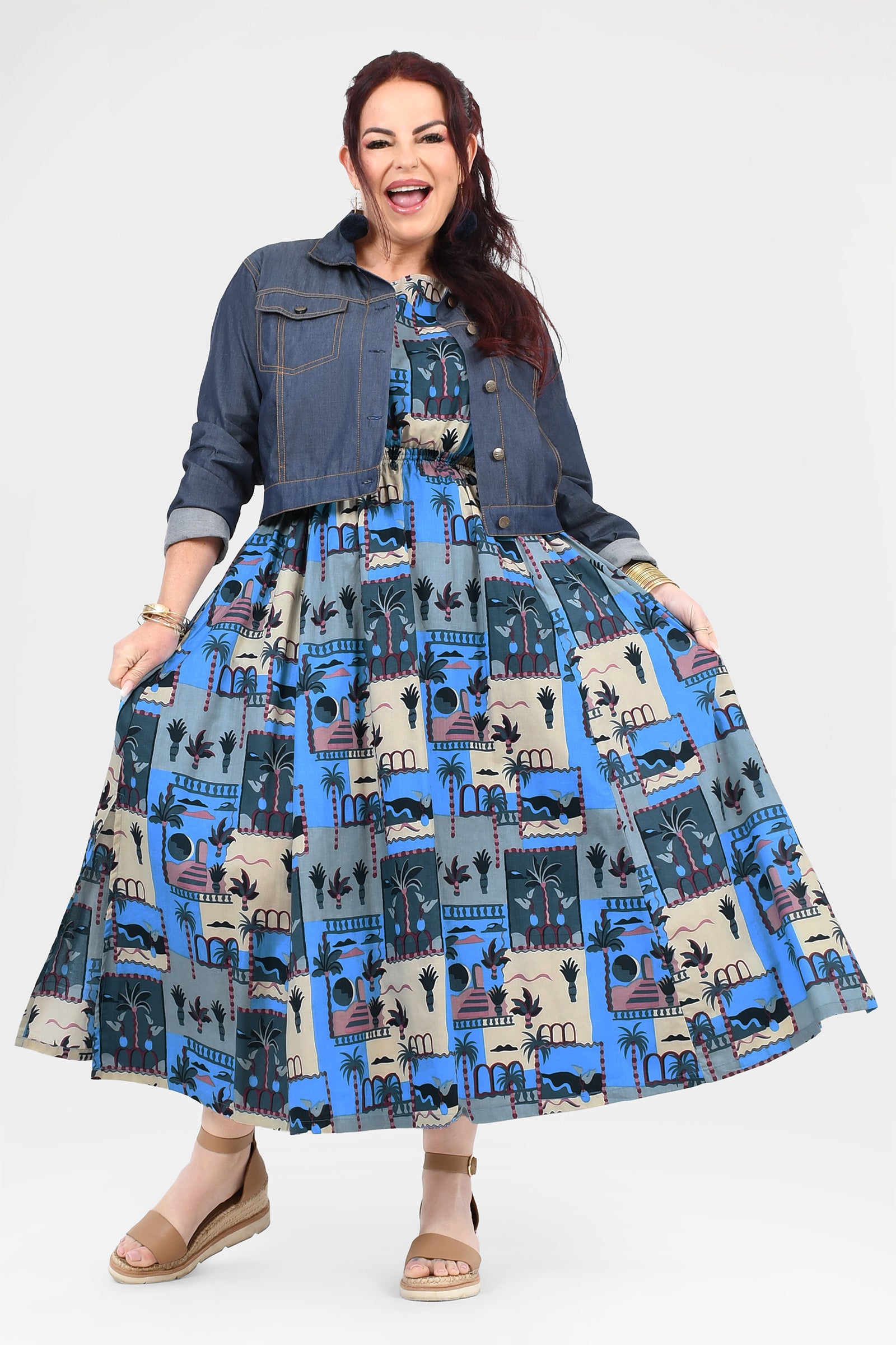 Blue-and-cream illustrated long dress worn under dark denim button shirt