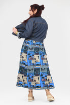 Back view of blue-and-cream illustrated long dress with dark denim jacket and full skirt