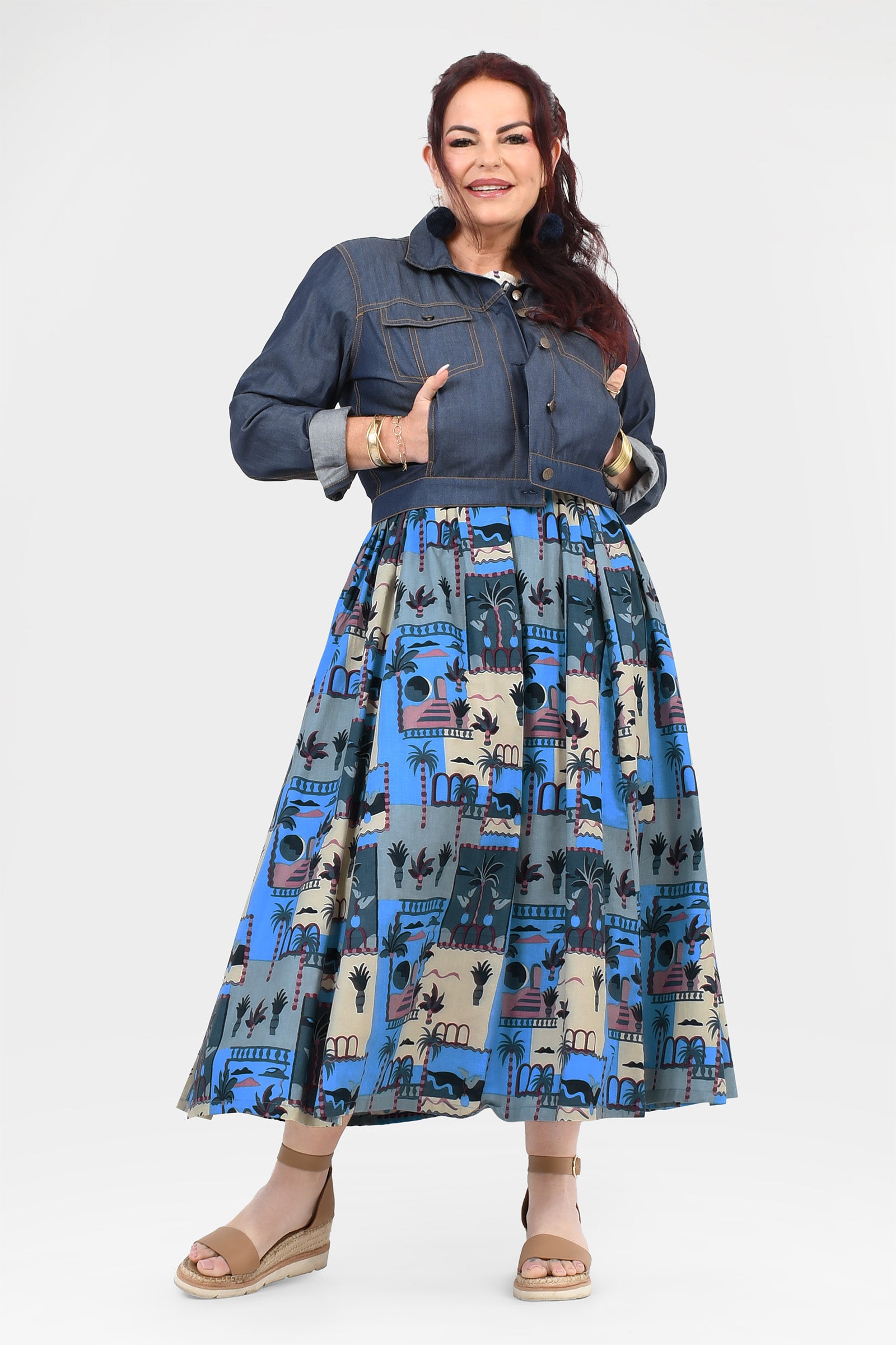 Blue-and-cream illustrated long dress with dark denim button jacket and gathered full skirt