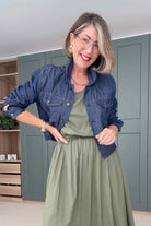 Blue denim jacket with button front, two chest pockets, and long sleeves