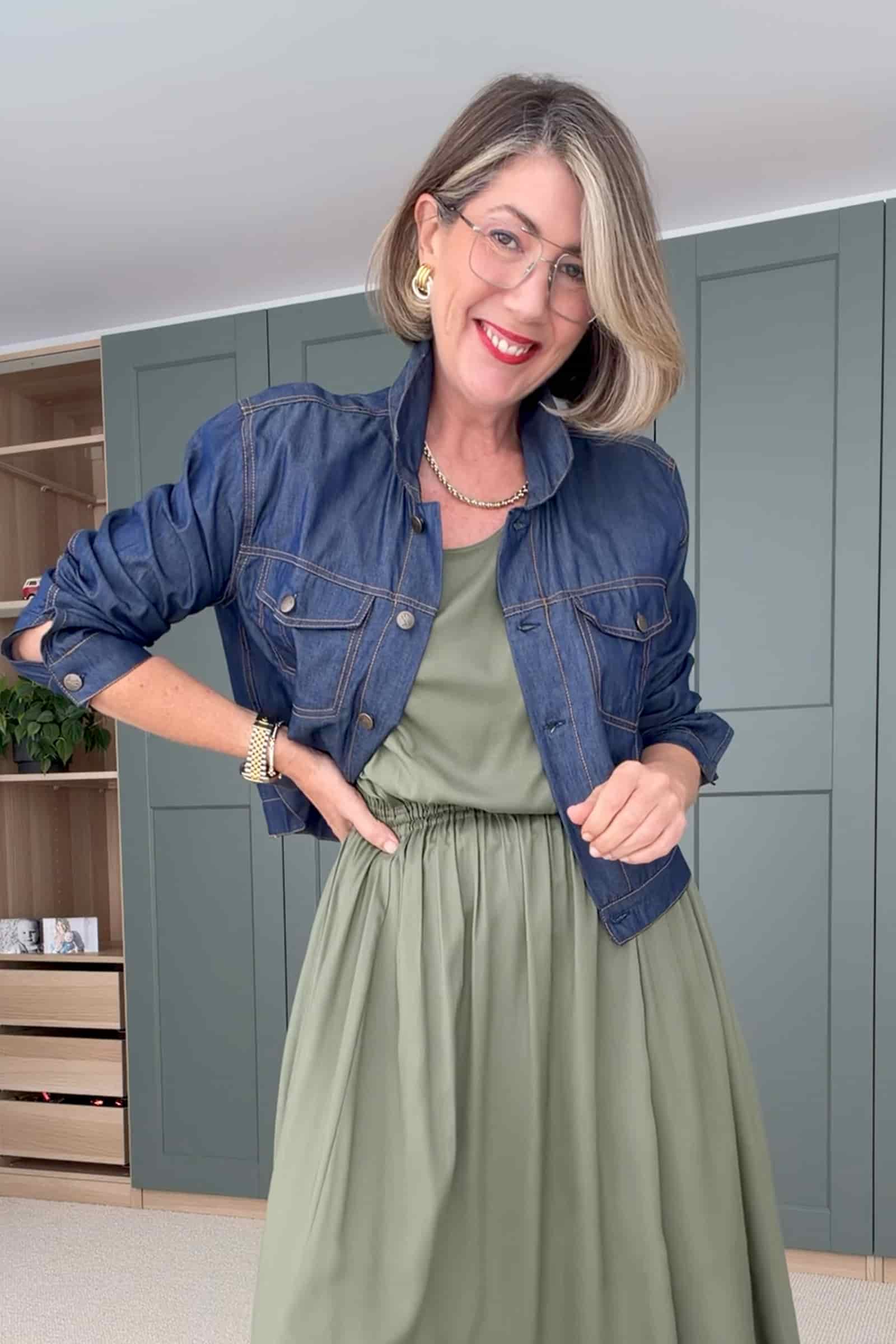 Blue denim jacket with button front, two chest pockets, and long sleeves