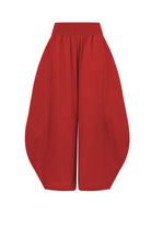 Dark red wide-leg pants with elastic waistband and roomy, draped legs.