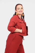 Dark red cropped jacket with pointed collar, button closure, and flap pockets