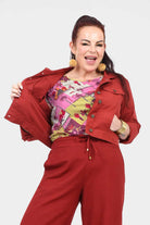 Dark red jacket with button front, flap chest pockets, and pointed collar