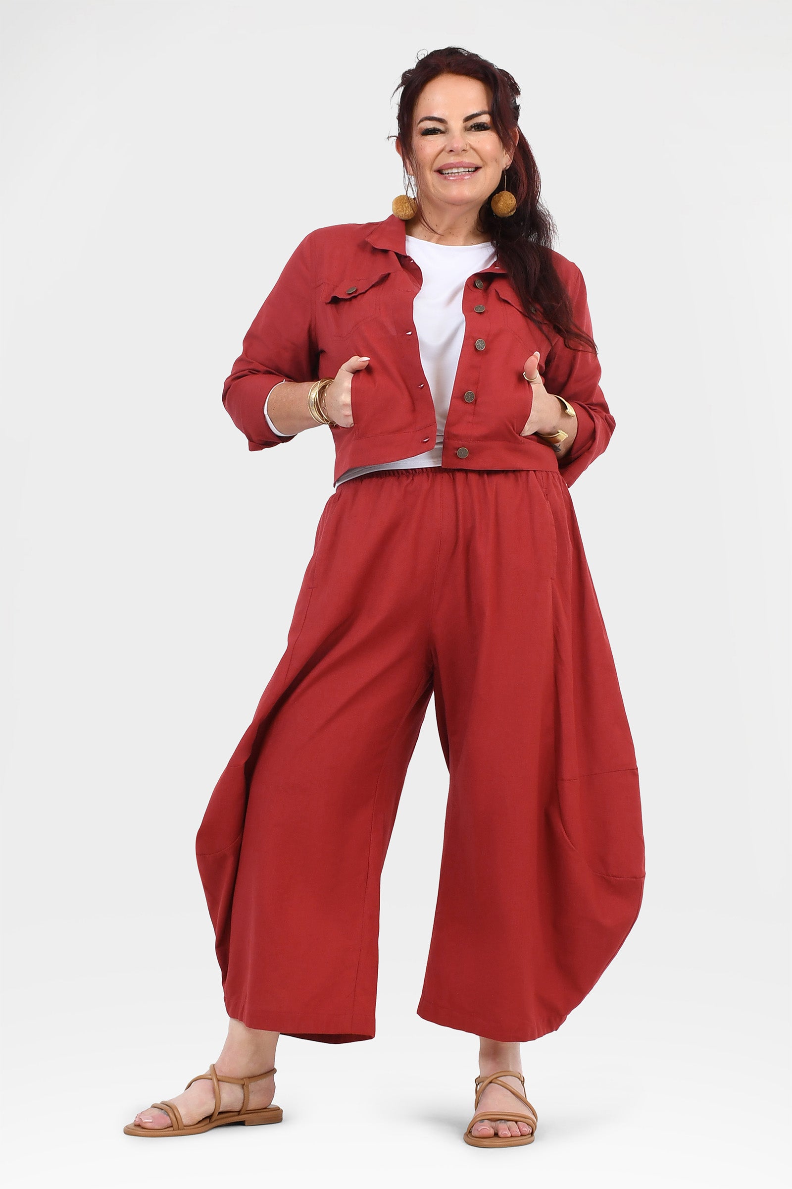Wide-leg dark red pants with elastic waistband and ankle-length drape.