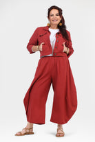 Wide-leg dark red pants with elastic waistband and ankle-length drape.