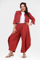 Front view of dark red wide-leg pants with elastic waistband and loose fit.