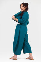 Dark teal wide-leg pants with relaxed drape and elastic waist