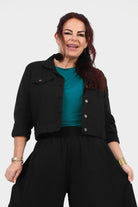 Black cropped jacket with snap buttons and flap chest pockets, 3/4 sleeves