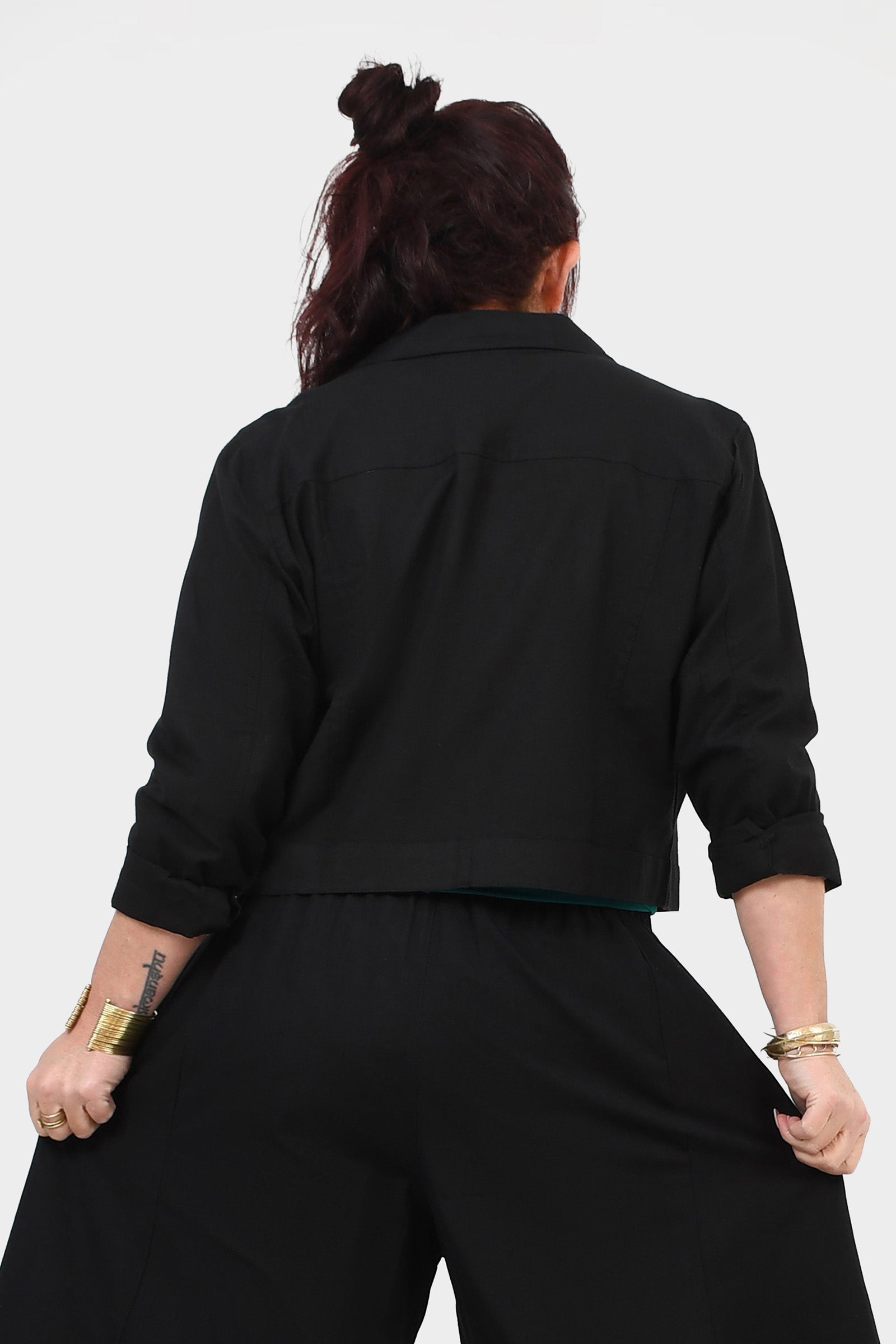 Black cropped jacket back view with stand collar and button details