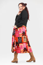 Woman wearing a colorful apron with geometric patterns on a white background