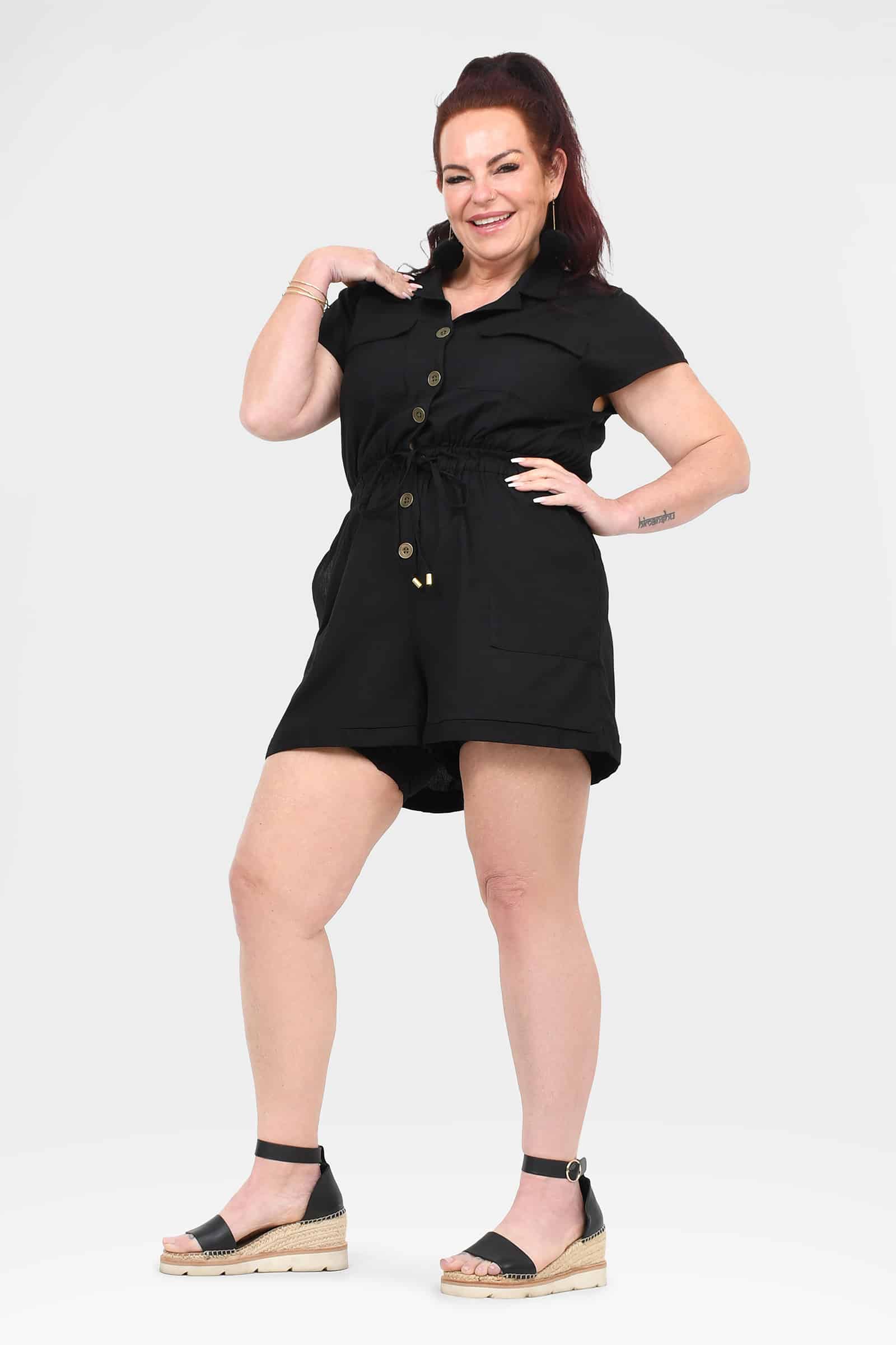 Black button-front short-sleeve romper with tie waist and above-knee pockets