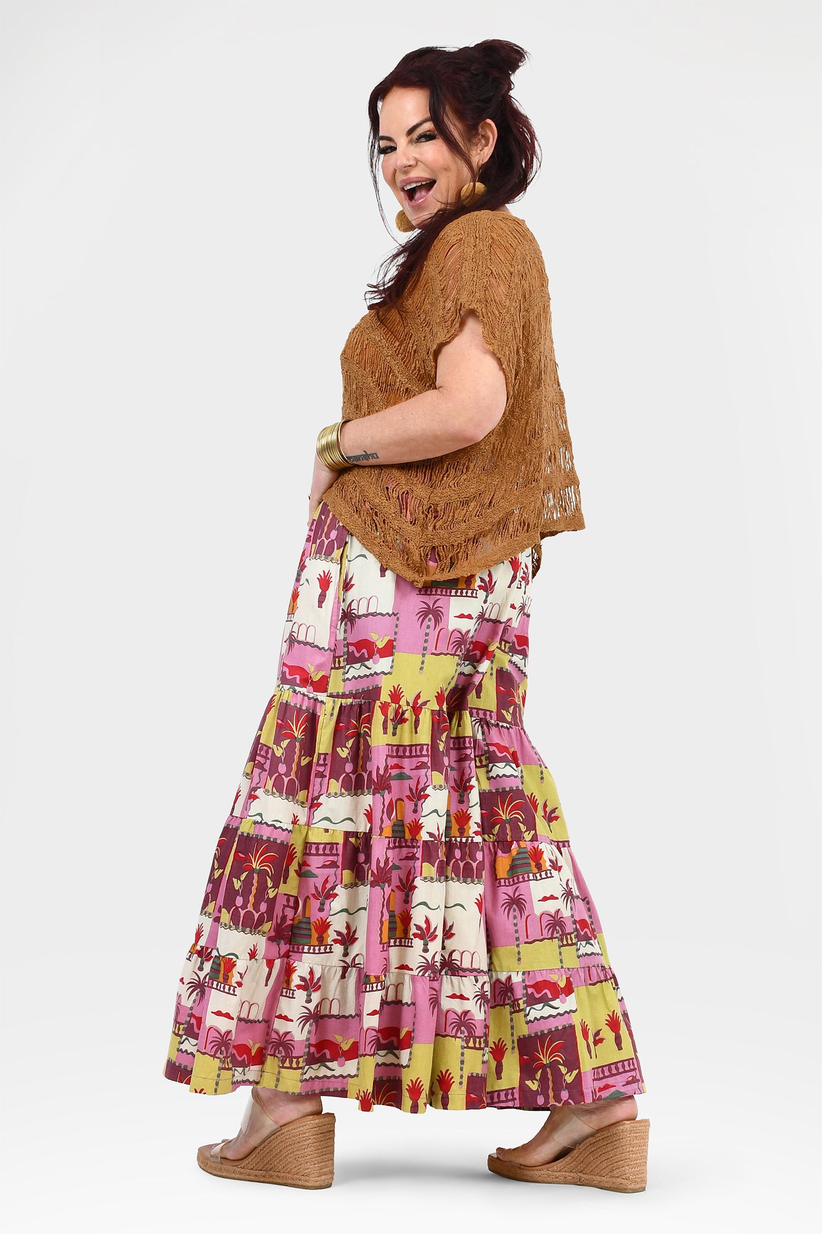 Havana pants side view: brown lace top worn with pink tiered midi animal print