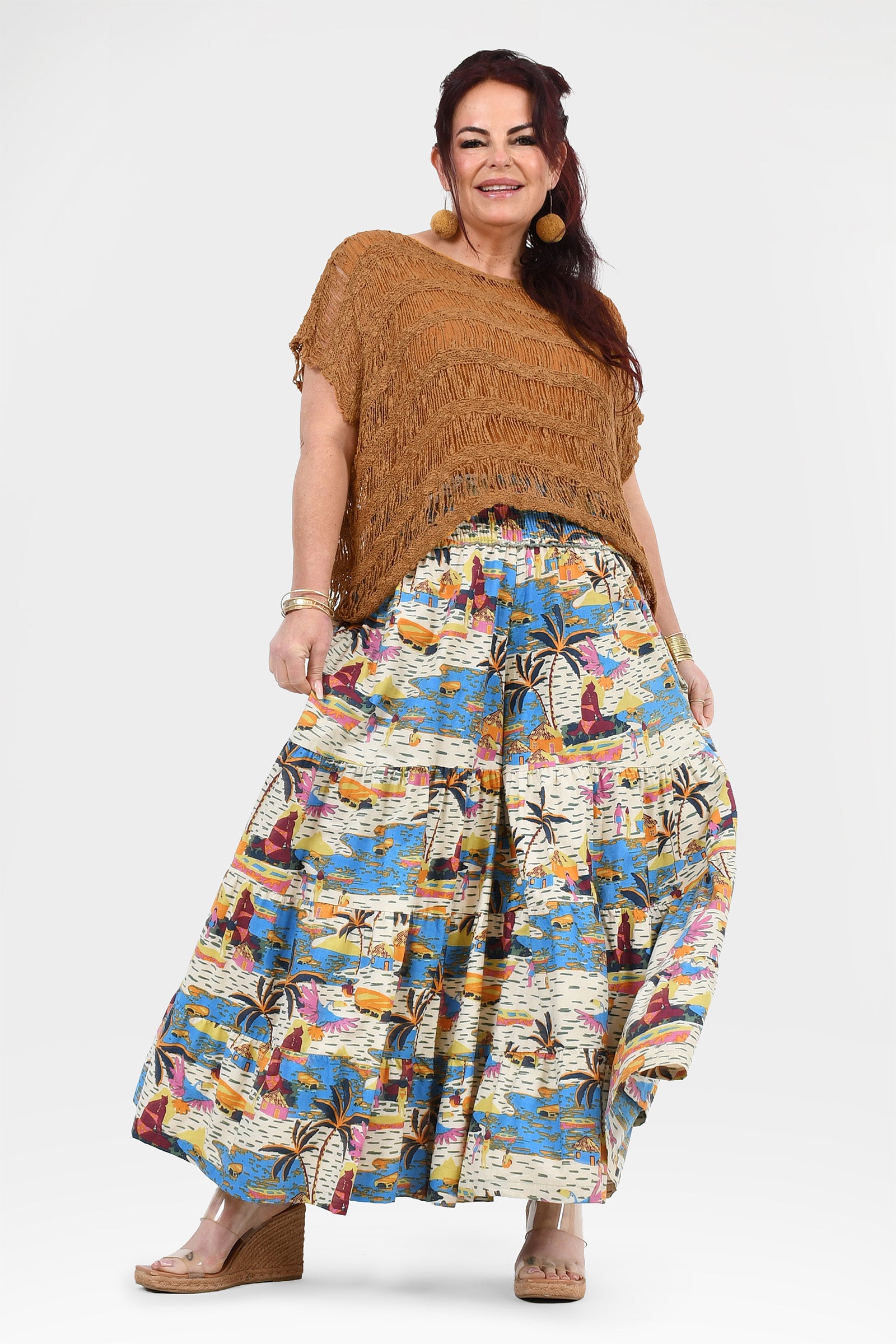 White, blue, and orange tropical print wide-leg pants with elastic waistband and roomy fit