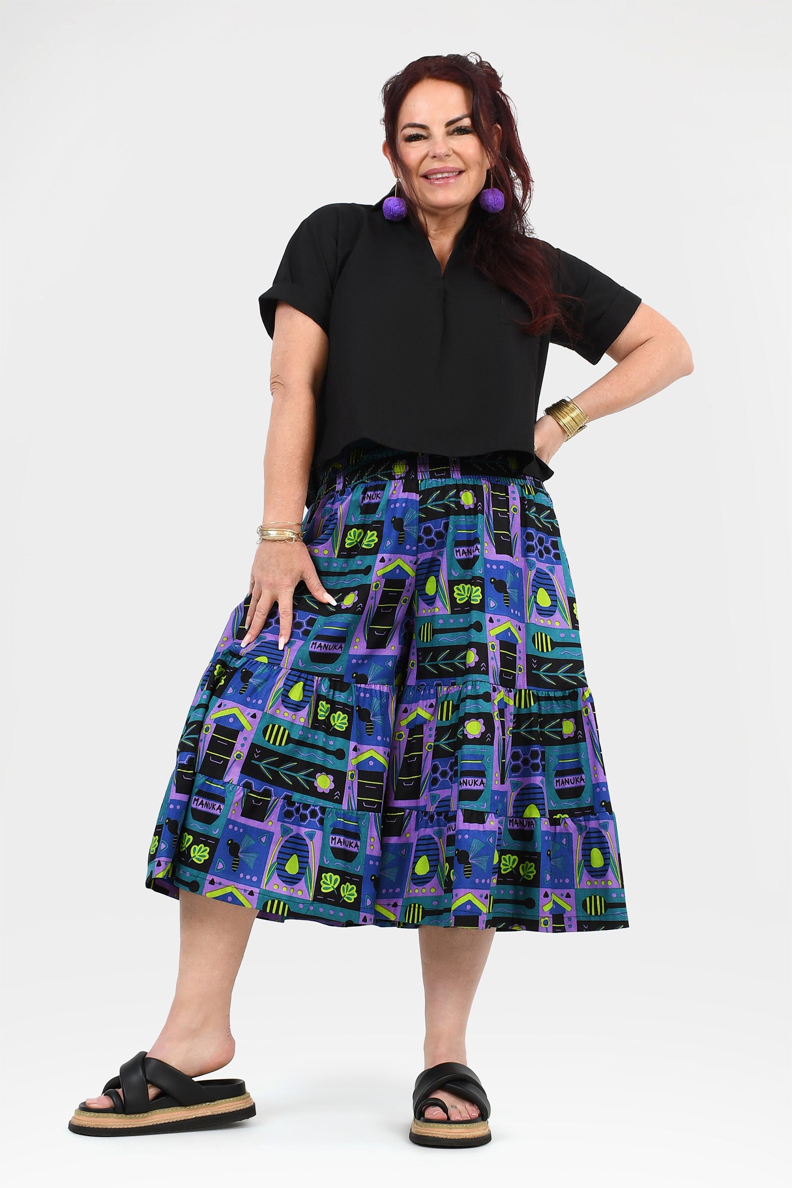 3/4 pants with black waistband and colorful teal, purple, and lime print