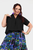 Black V-neck short-sleeve top with relaxed drape and side seam detail