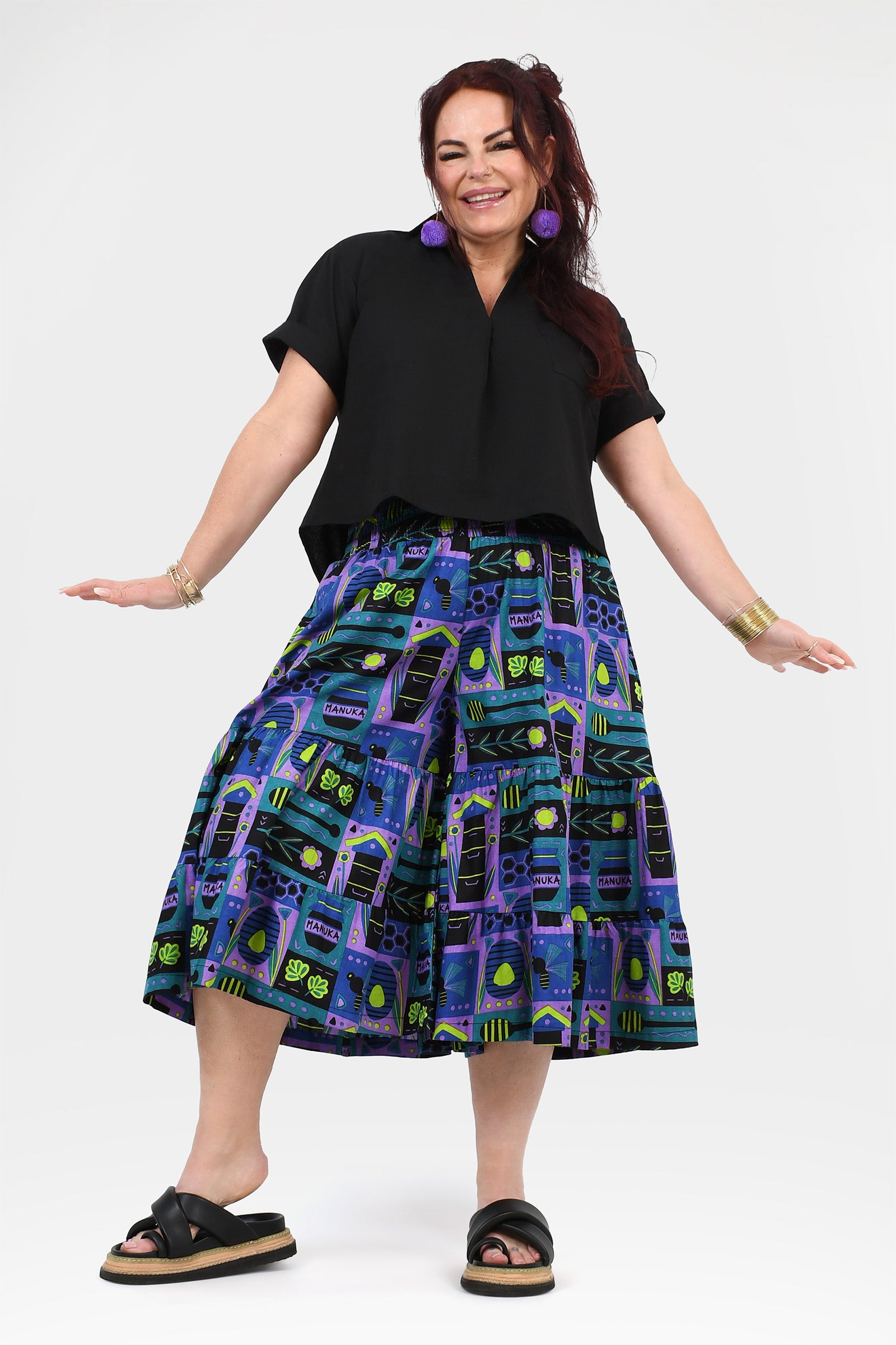 3/4 pants with black waistband and bright teal-purple geometric print