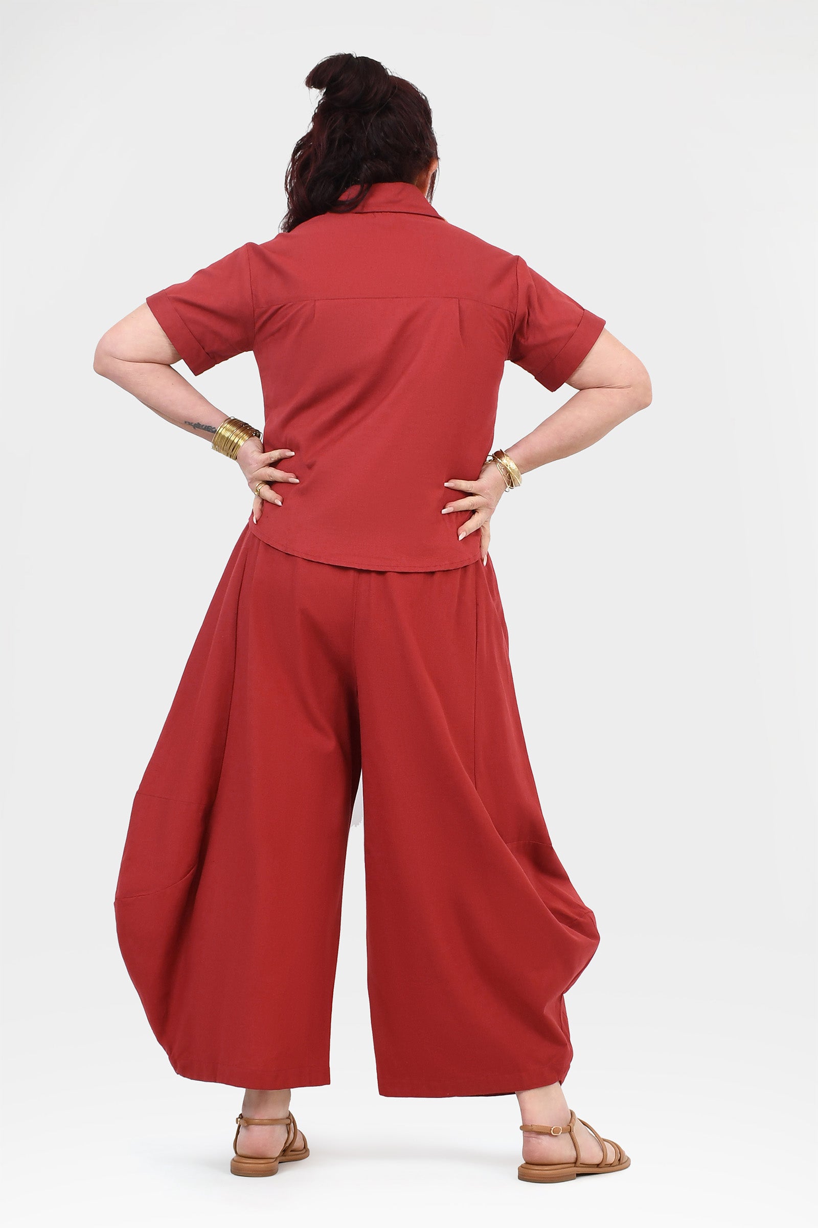 Back view of dark red wide-leg pants with elastic waistband and gathered back.