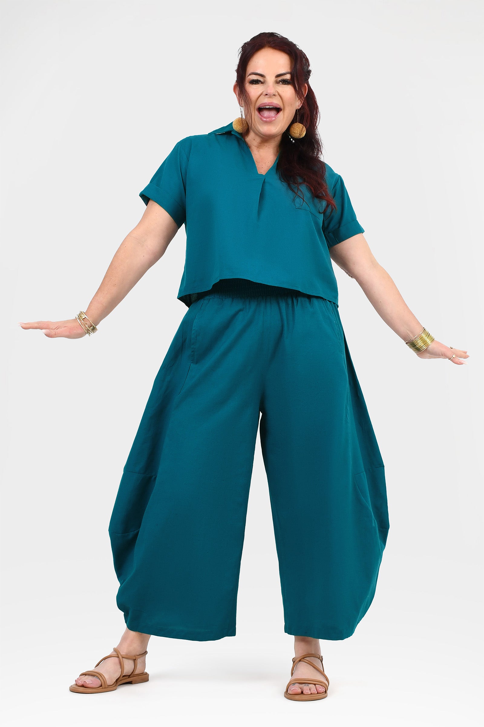 Dark teal wide-leg pants with gathered elastic waistband and flowing legs
