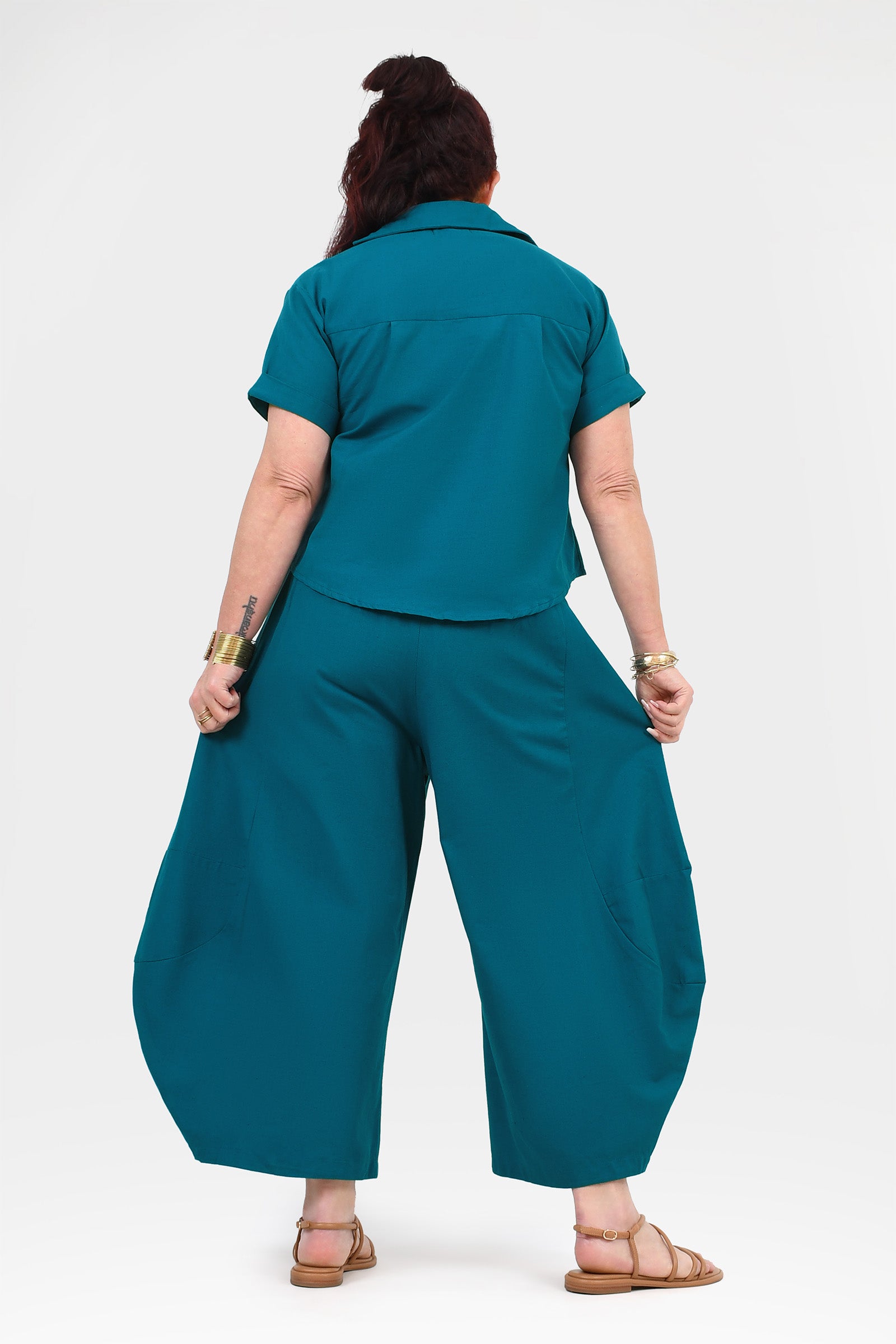 Dark teal wide-leg pants back view with relaxed drape