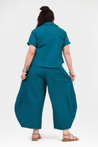Dark teal wide-leg pants back view with relaxed drape