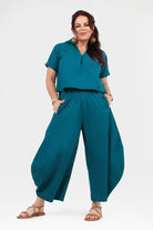 Dark teal wide-leg pants with elastic waistband and flowy legs