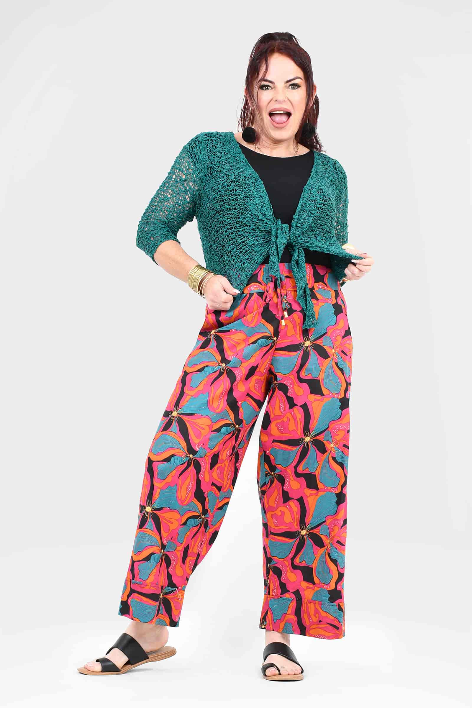 Wide-leg pants with vibrant pink and teal abstract leaf pattern