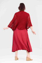 Amelie dress with dark red knit shawl overlay, midi length, flared sleeves