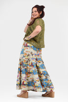 Wide-leg pants with white background and blue-orange tropical print, loose gathered drape