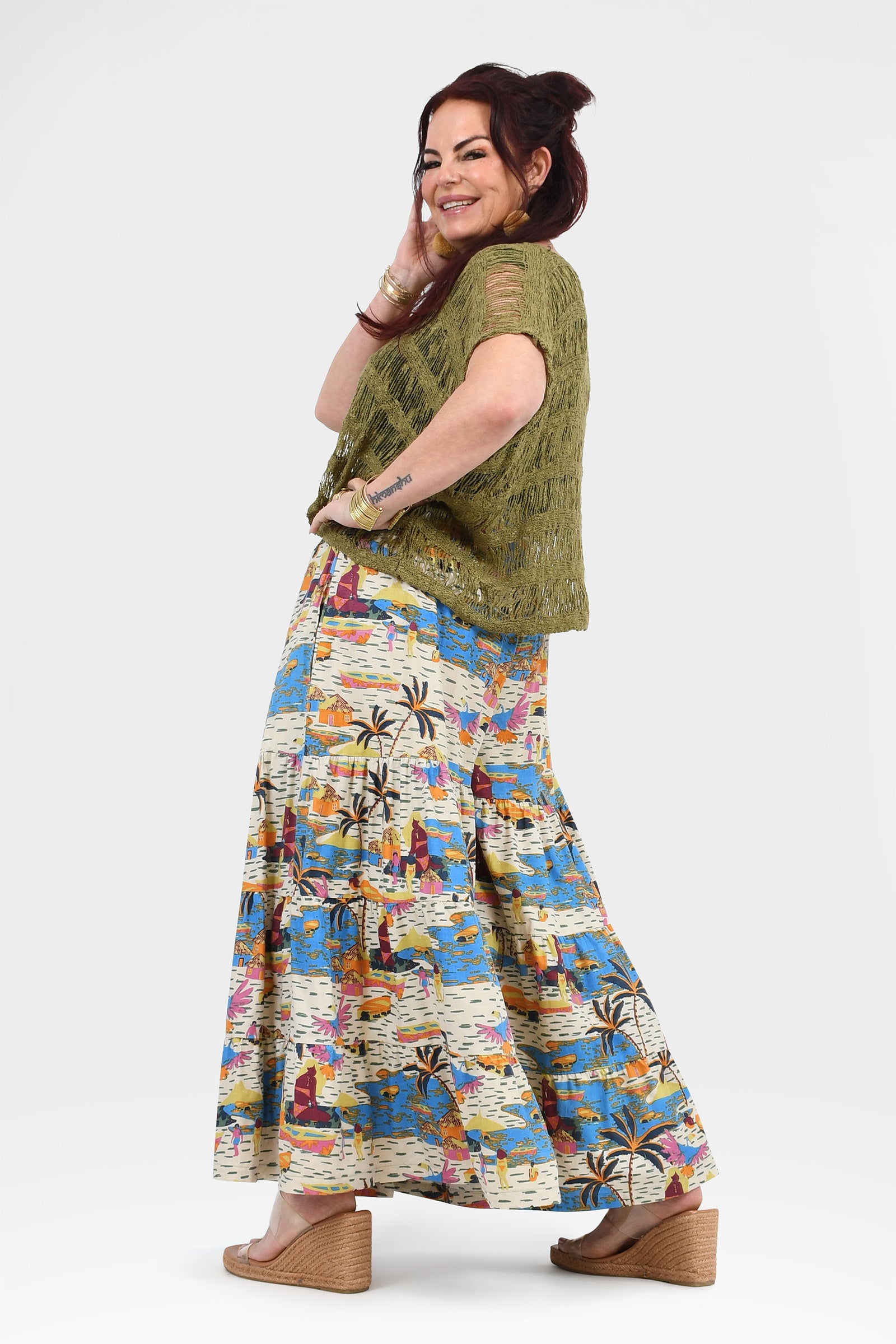 Wide-leg pants with white background and blue-orange tropical print, loose gathered drape