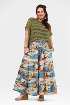 White and multicolor jungle print wide-leg pants with elastic waistband, wide flowing legs