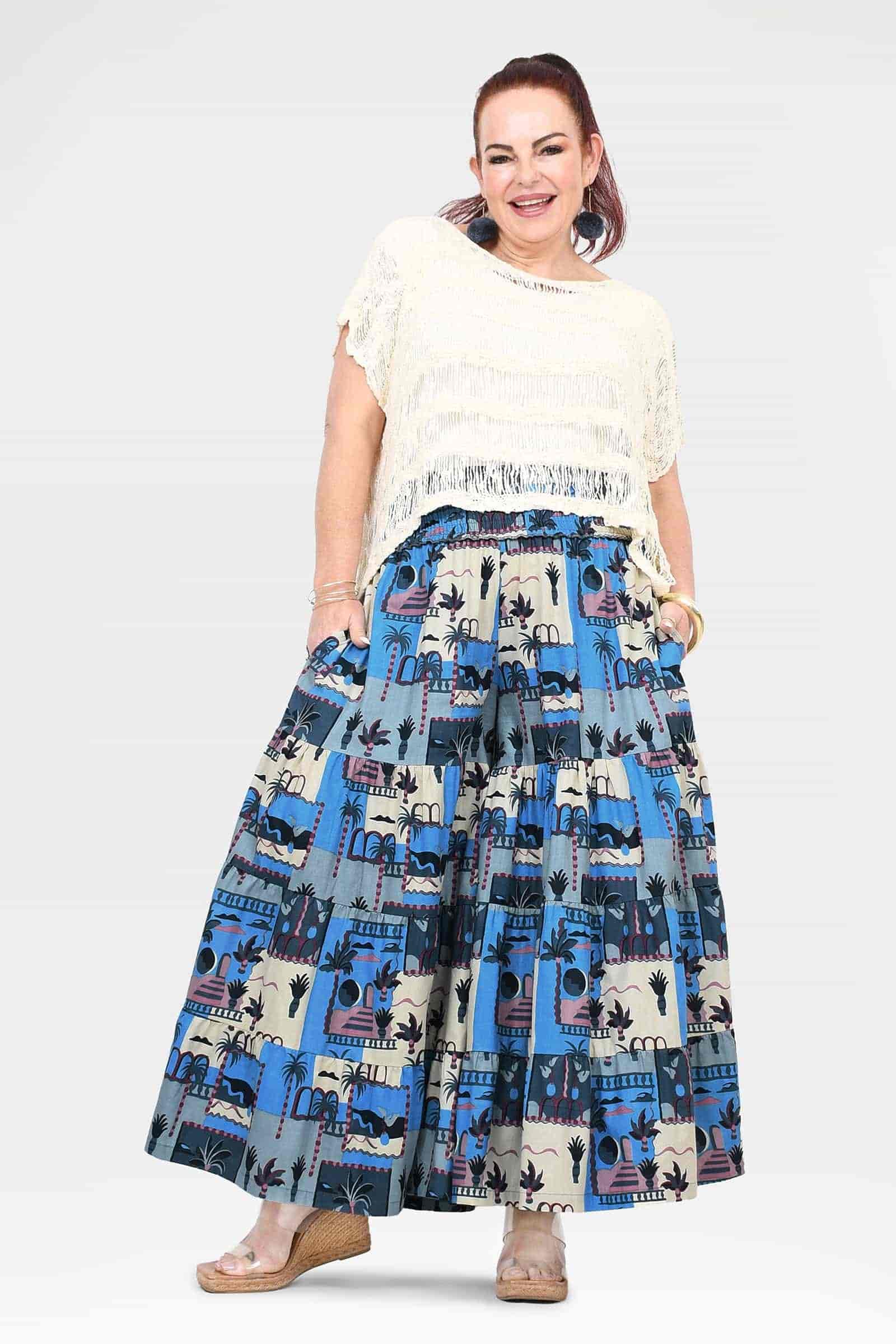 Blue and cream patterned wide-leg pants with tiered ruffles and wide waist panel