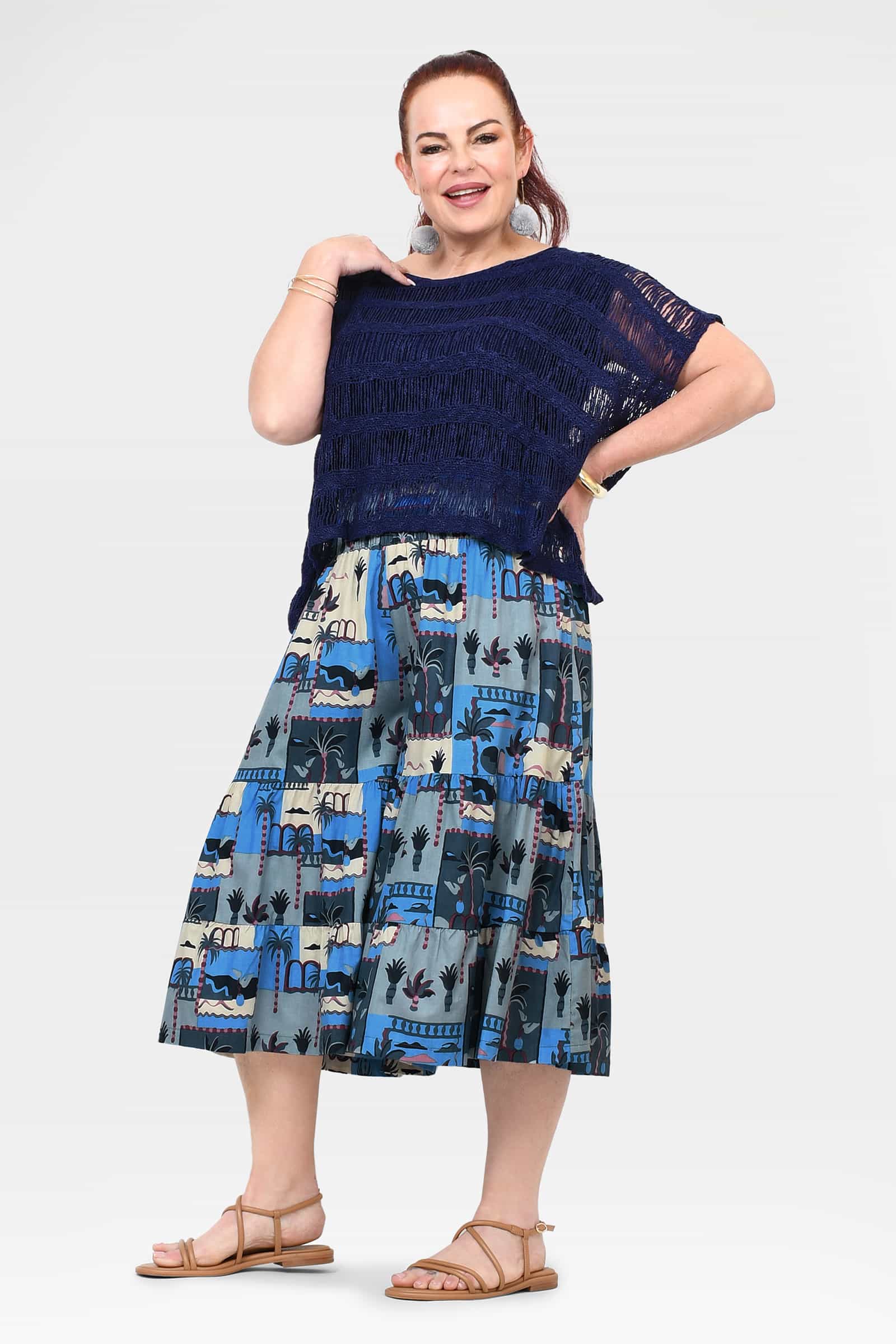 Front view of navy and blue printed 3/4 pants with tiered, skirt-like hem