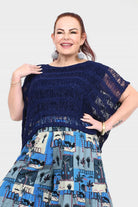 Dark navy popcorn knit top with frayed shoulder fit and blue/white tiered village print